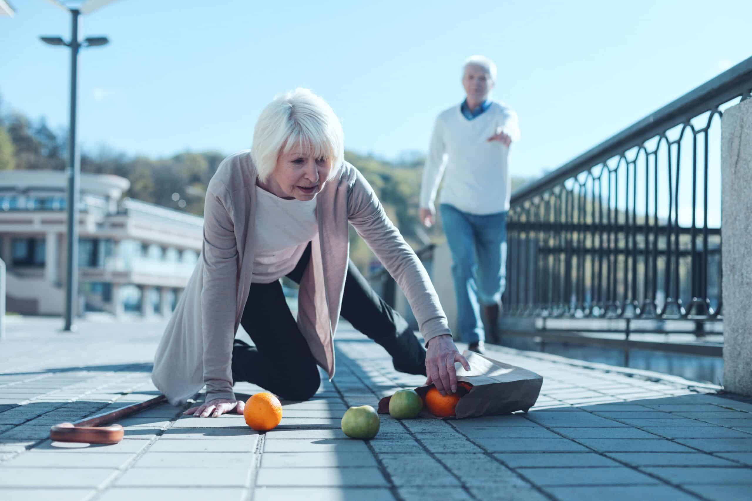 woman falling on uneven sidewalk